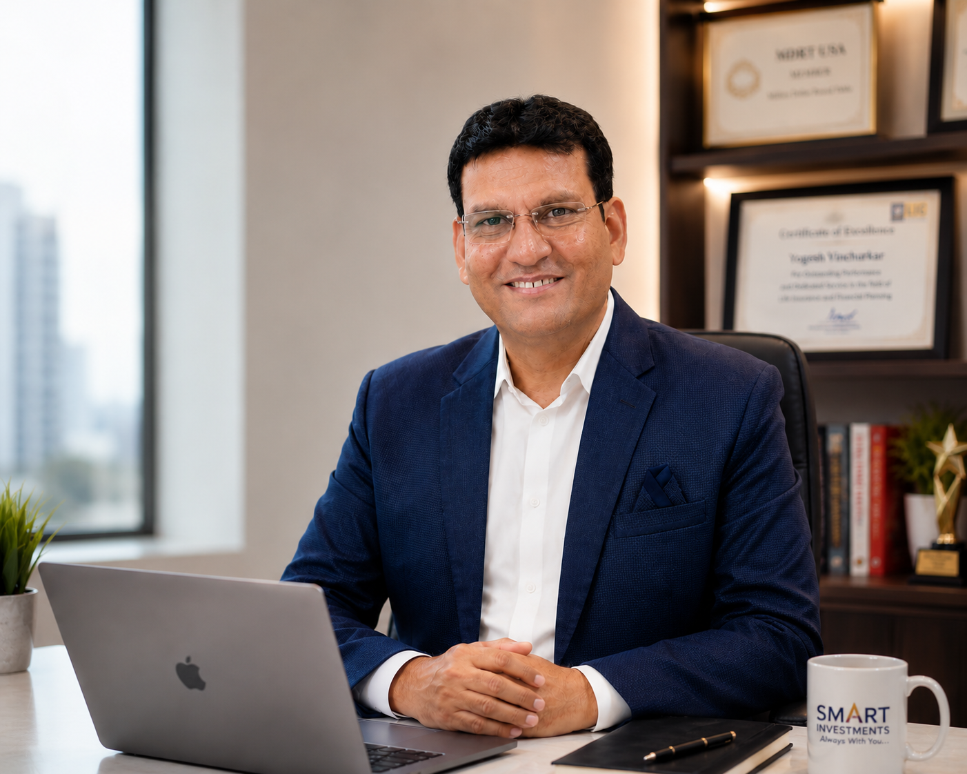 Yogesh Vinchurkar seated at his Smart Investments office desk with awards behind him
