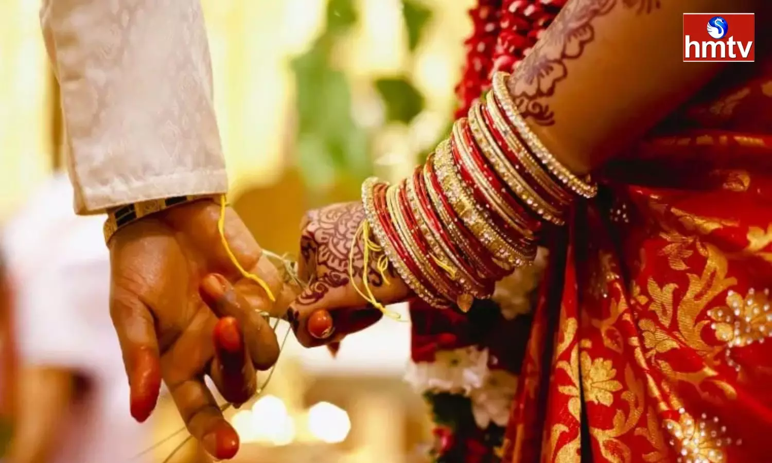 Bride and groom holding hands at a traditional Indian wedding